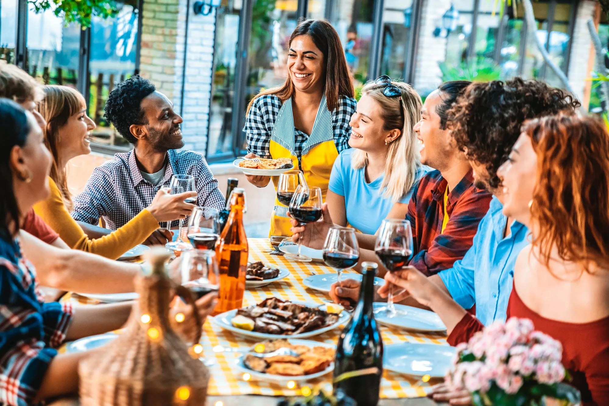 Happy friends having fun at bbq dinner outdoor in barbecue backyard home party