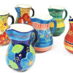 Close up of 6 hand painted ceramic jugs